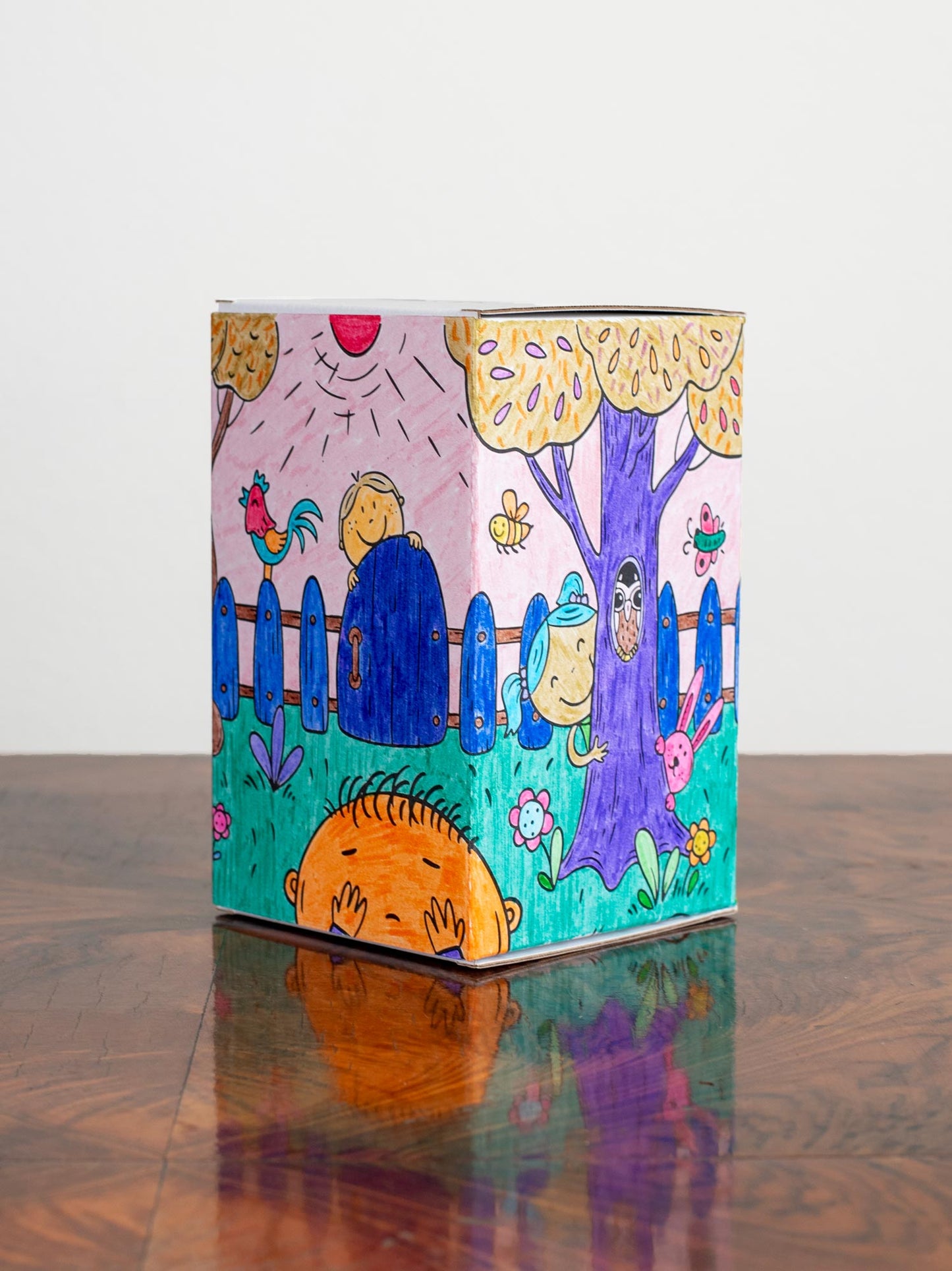 Filled in coloring book style cardboard box. Drawn in a bright and colorful way.