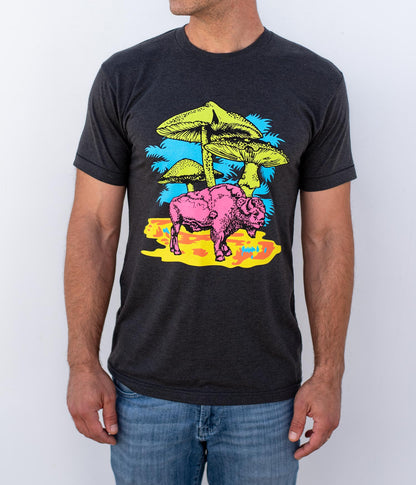 Man wearing a black shirt with a pink buffalo and mushrooms. 